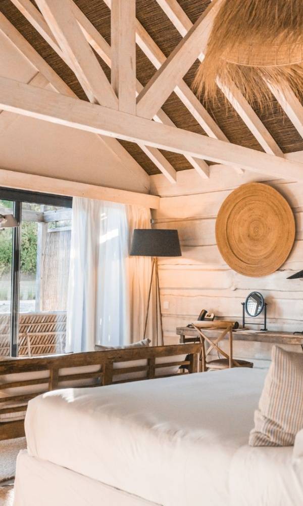  Exterior view of the Sublime Hotel in Comporta, showcasing its modern architecture blending with natural surroundings, with lush greenery and serene ambiance